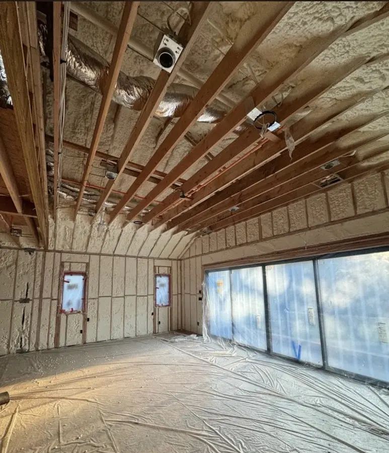 Interior walls and ceiling insulated with spray foam during new construction in Brooklyn